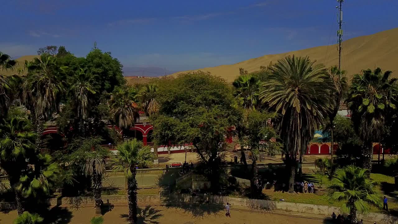 Pedestal Aerial Drone Shot Over Beautiful Resort at Huacachina Oasis, Peru, South America