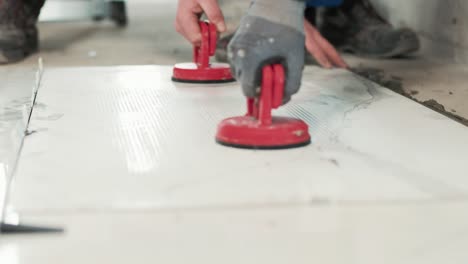 placing a big tile on the ground with vacuums