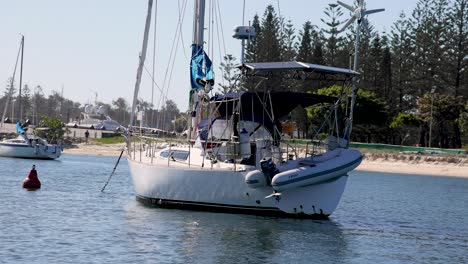 sailboat anchored near shore with scenic background