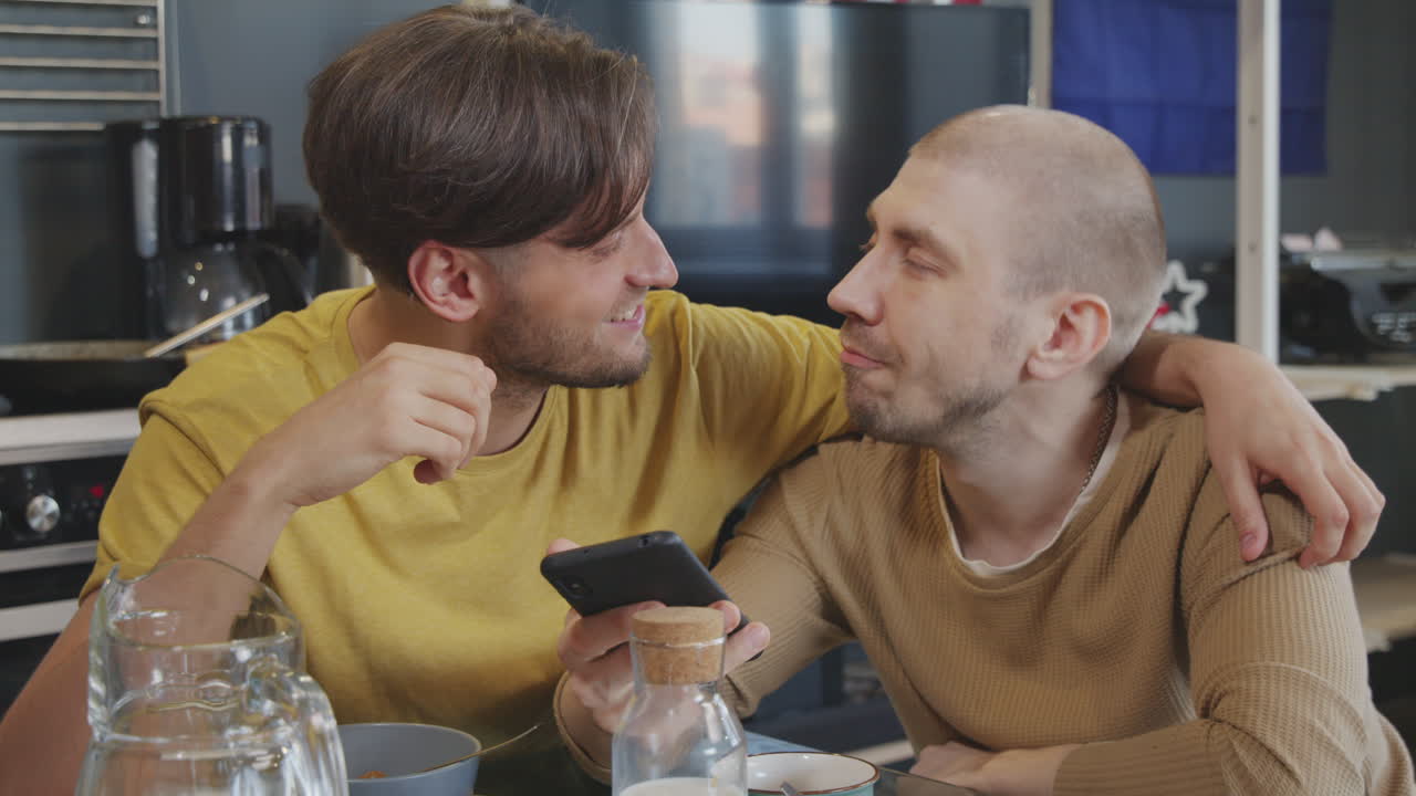 Happy Same-Sex Couple Chatting and Using Mobile Phone