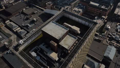 4k 60 fps birdseye aerial drone flight over manchester arndale tower with retail buildings rooftops below