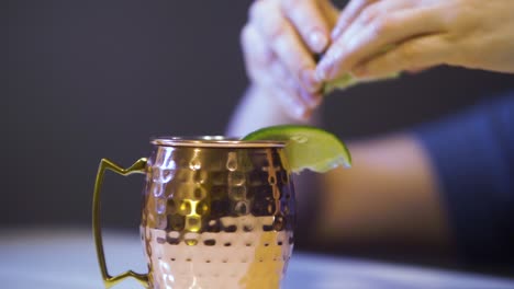 hand squeezed lime on moscow mule cocktail in typical copper mug