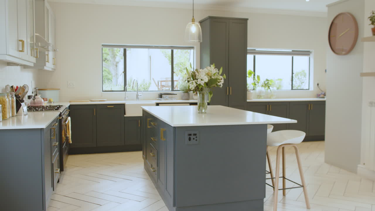 Modern kitchen with elegant island and fresh flowers, bright and inviting space, at home