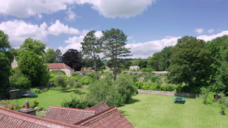 aerial flyover of a large family home in a quaint village