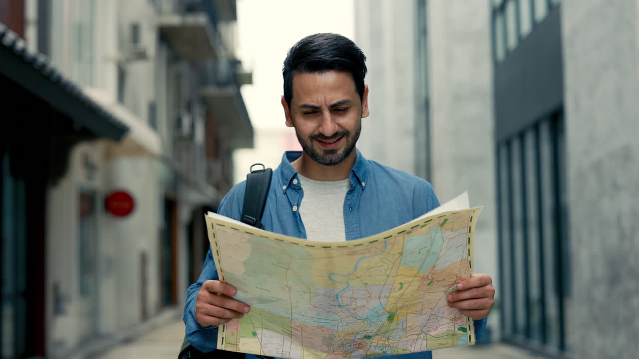 Happy Male Tourist Exploring City Street with a Map