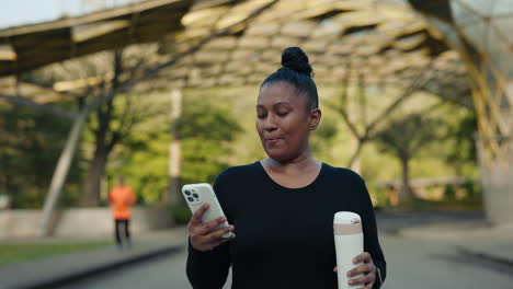 a woman using her phone while walking outside