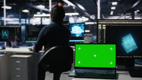 engineer in data center coding with generative ai assistance on chroma key laptop