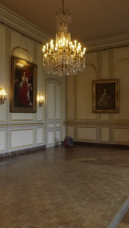 grand hall interior with chandelier and portraits