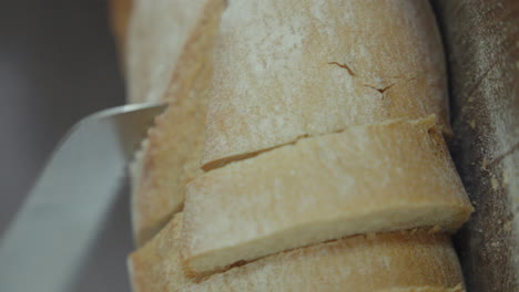 Close-up-of-a-knife-slicing-freshly-baked-bread