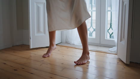 barefoot girl feet moving cozy apartment close up. unrecognizable woman dancing