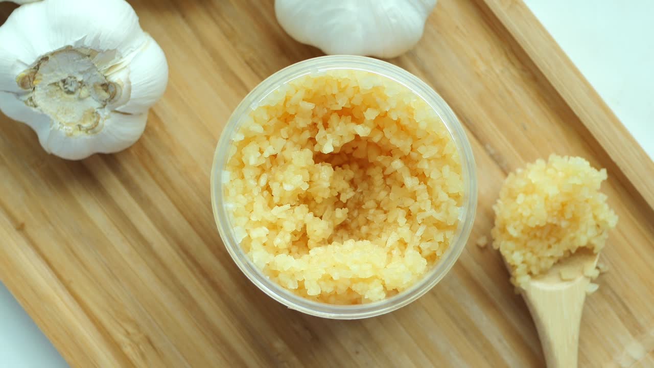 Close up of minced garlic on a wooden spoon ,