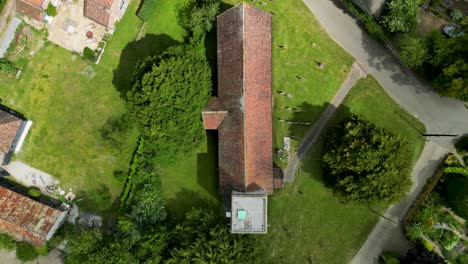 a top-down push-in shot towards the top of st margaret of antioch church in womenswold