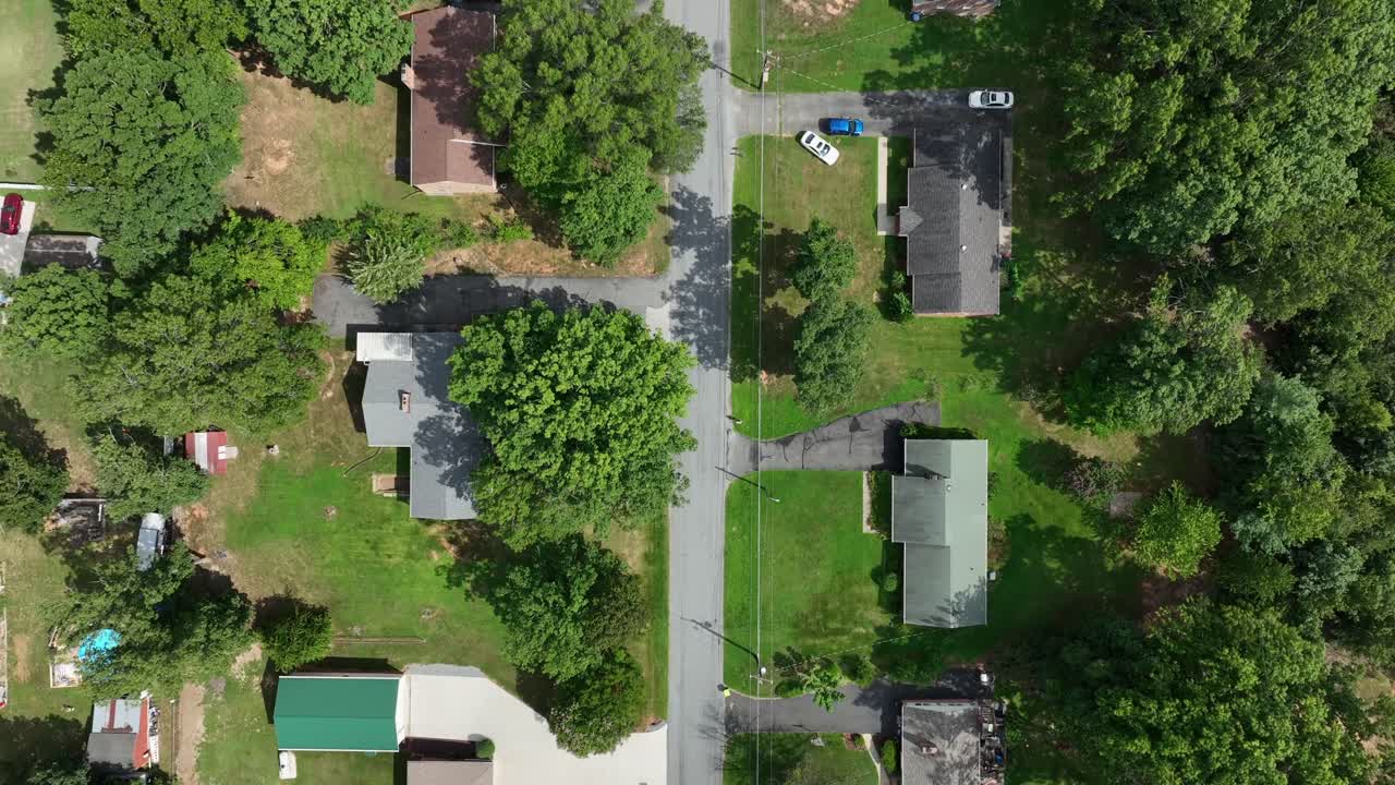 Typical American Suburb neighborhood with one family houses and green yards in summer. Aerial top down flyover. Peaceful calm residential area in Virginia state