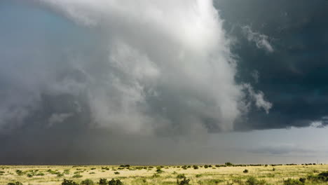 strong storm clouds spin over beautiful summer fields