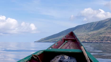 taking a local traditional fishing boat to a remote, secluded tropical island, overlooking the bow, watching atauro island, timor leste, southeast asia