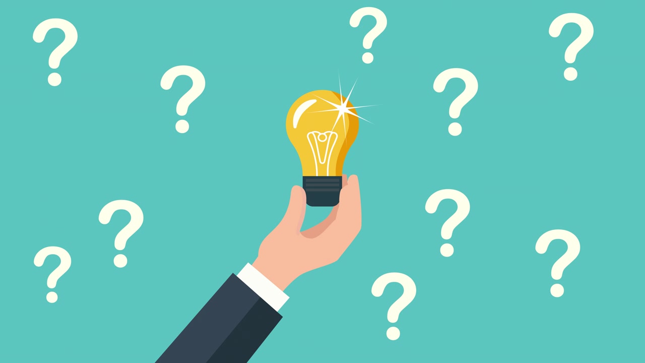 Hand Holding Glowing Light Bulb Among Question Marks