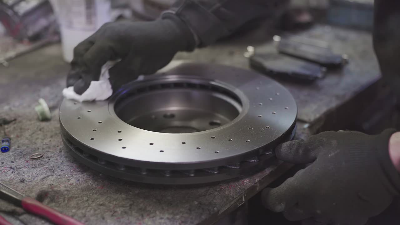 Mechanic cleans brake discs 2