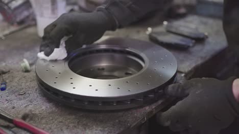 mechanic cleans brake discs 2