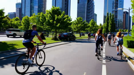 people cycling on a bike path in an urban city