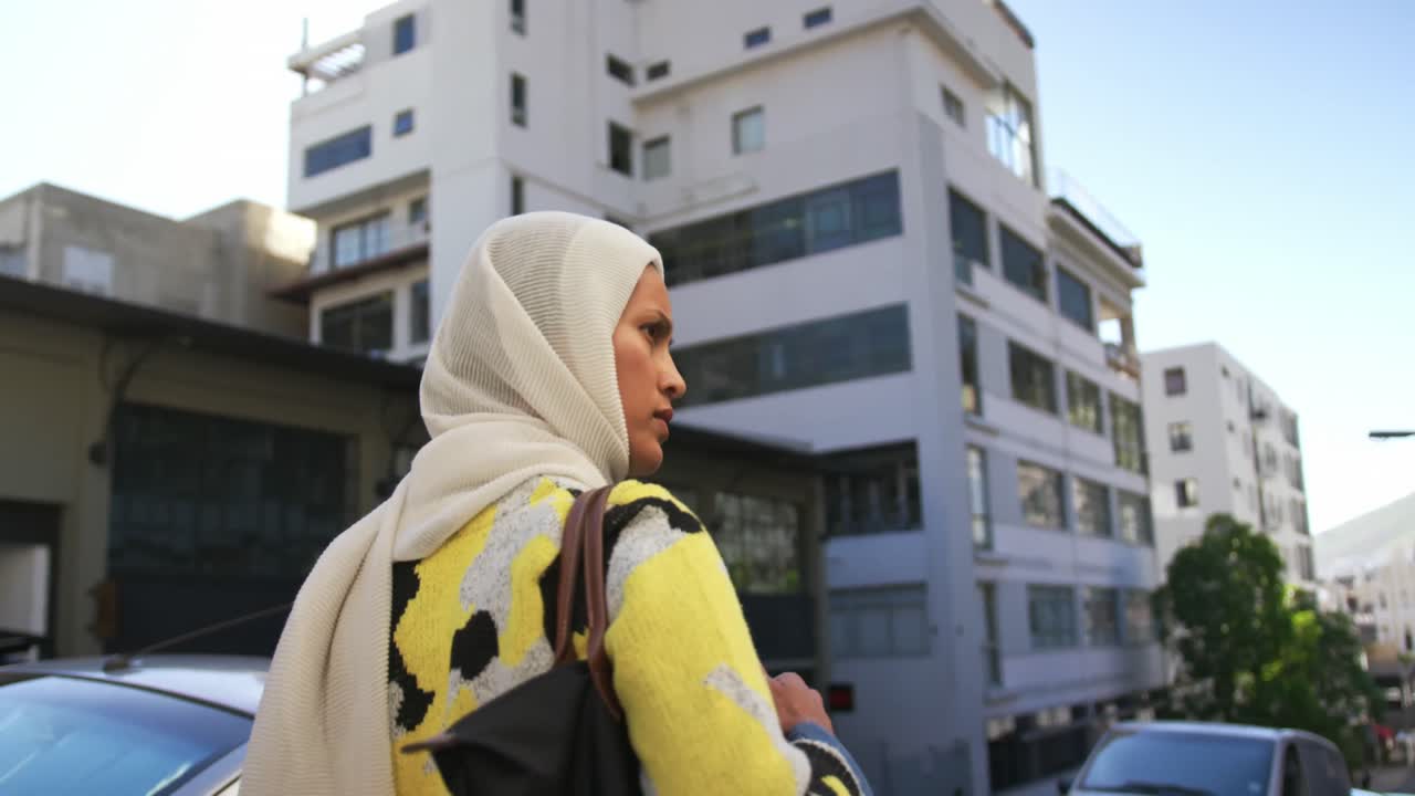 Young woman wearing hijab out and about in the city