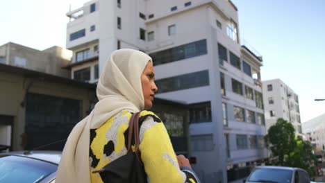 young woman wearing hijab out and about in the city