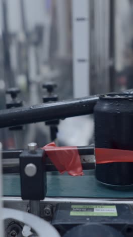black cans on a production line in a factory