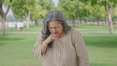 Sick-Indian-old-woman-suffering-from-cold-and-cough-in-park