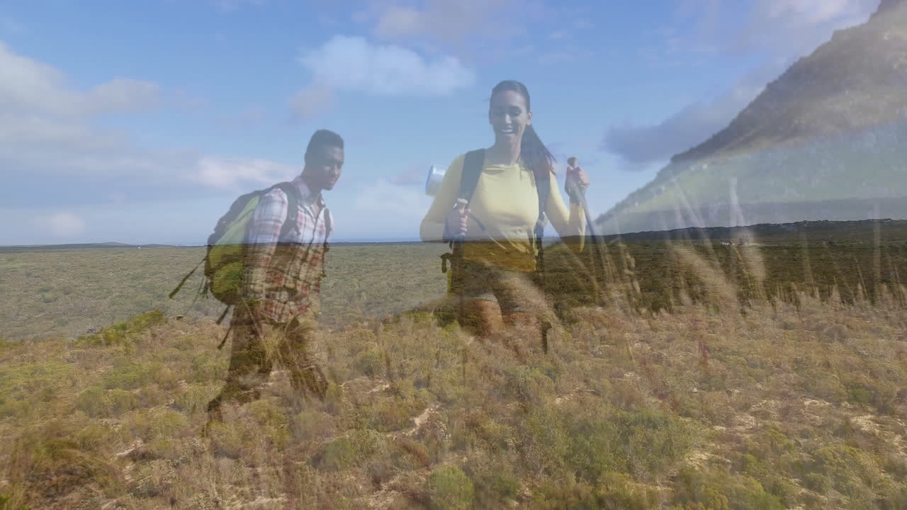 Two hikers trekking uphill with poles and backpacks, displaying animated business chart overlay