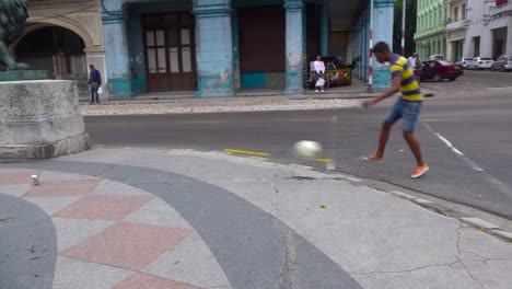 kids play soccer on the street in the old city of havana cuba