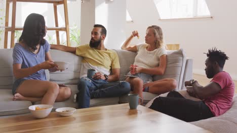 two couples having breakfast together at home