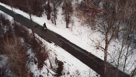 Conducir-Una-Motocicleta-En-La-Carretera-A-Través-Del-Bosque-Cubierto-De-Nieve-En-El-Rango-De-Wasatch,-Cerca-Del-Cañón-Hobble-Creek-En-Utah-En-Invierno