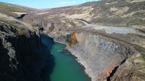 aerial drone tilt up shot over studlagil canyon in iceland