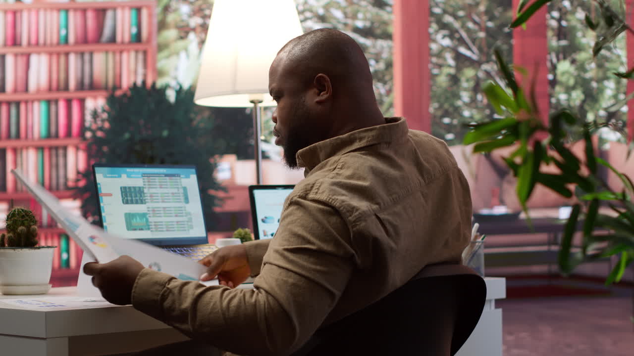 Entrepreneur examining accountancy data reports within the business operations