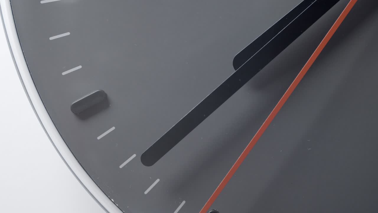 Clock Face in Realtime moving near 8 o'clock with seconds on white wall