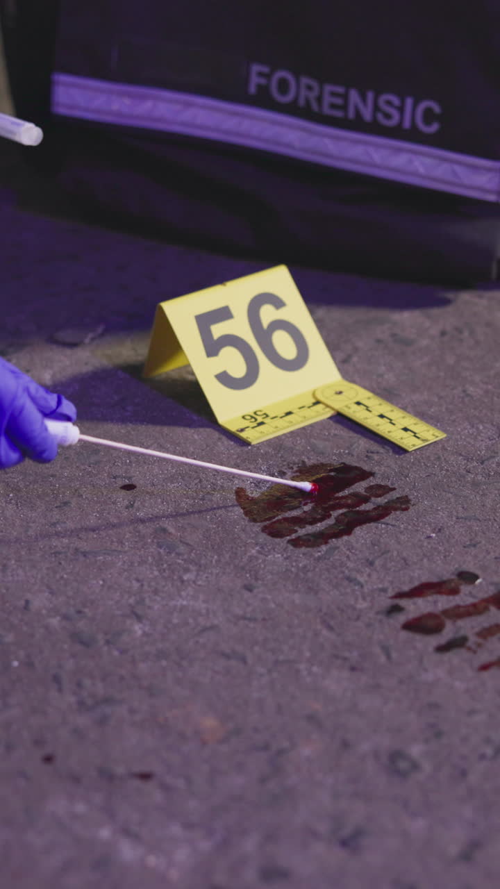 Forensic investigation of a crime scene with bloodstain and evidence tags
