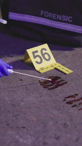 forensic investigation of a crime scene with bloodstain and evidence tags