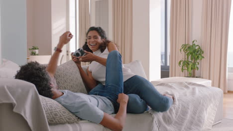 happy-couple-taking-photo-together-using-camera-having-fun-relaxing-at-home-on-sofa-enjoying-romantic-relationship