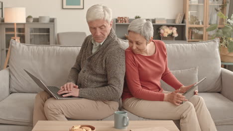 senior couple using technology at home