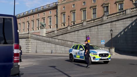 police van, car and officer at swedish national day celebration by royal palace