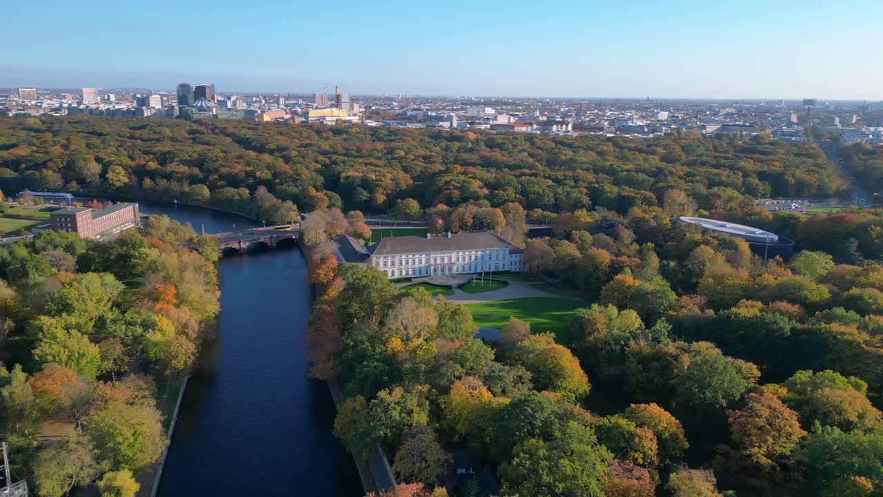 Schloss bellevue palace nestled among vibrant autumn foliage in tiergarten park, berlin, germany. Wonderful aerial view flight fly reverse drone