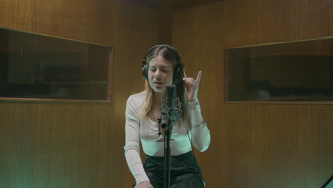 Beautiful-female-singer-working-in-music-studio