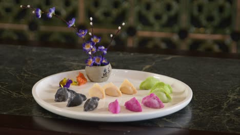 dumplings served on a white plate with traditional flowers for a meal