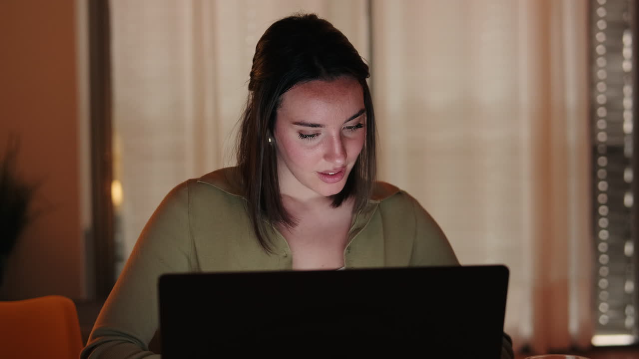 lose up of Woman Working From Home on Laptop at Night
