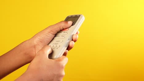 person using an air conditioner remote