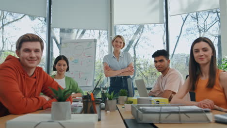 smiling startupers looking camera modern cabinet. five people sitting together