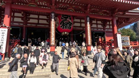 crowds of people visiting a traditional temple