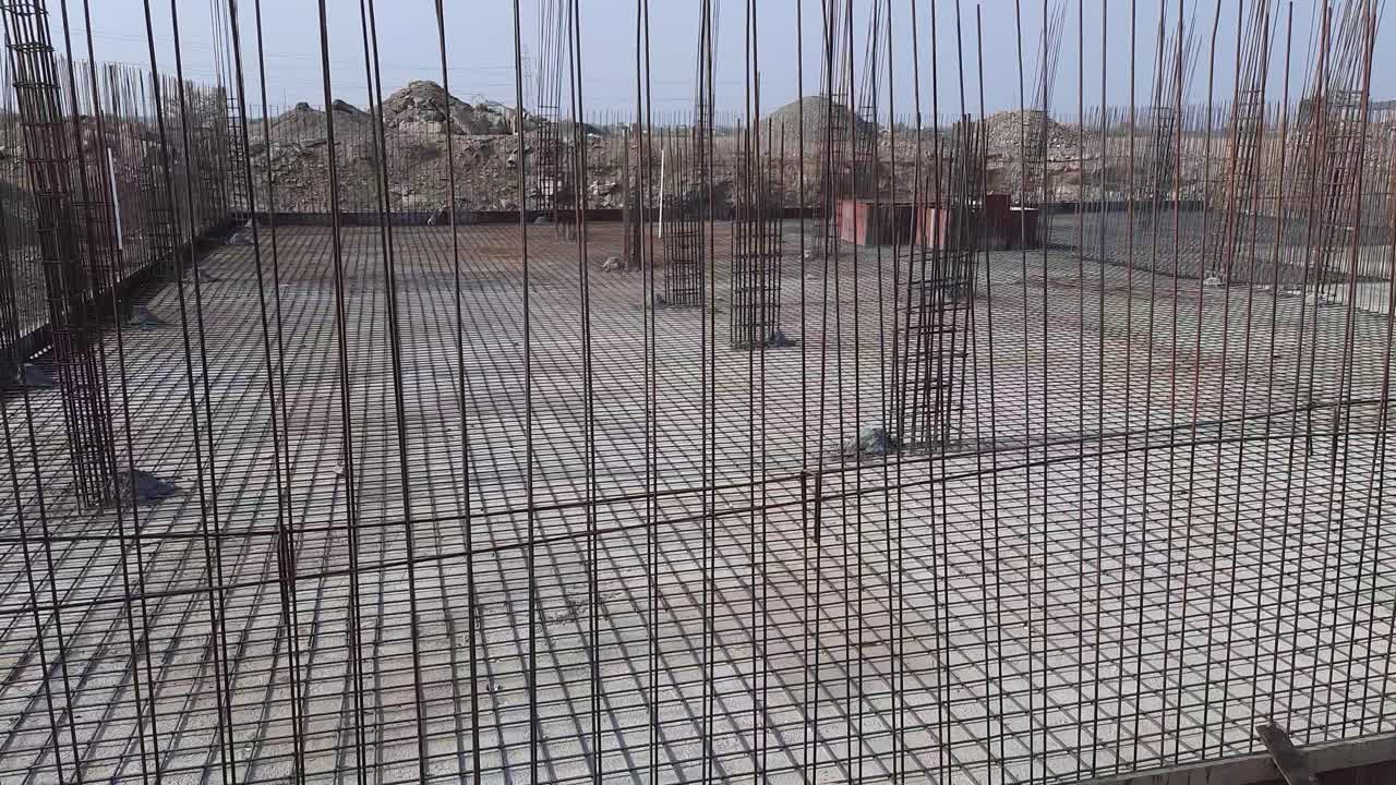 A close-up video shot of a fabricated steel reinforcement bar at the construction site. Reinforcement steel of house foundation structure at the construction site. making reinforcement metal framework