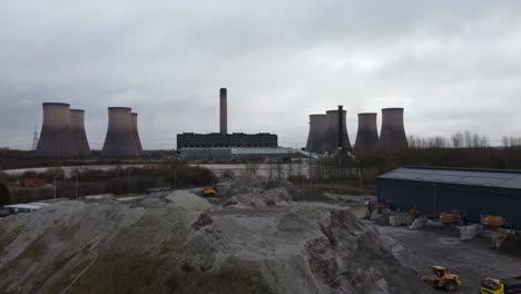 aerial view passing across coal fired power station site, fiddlers ferry smokestack overcast skyline