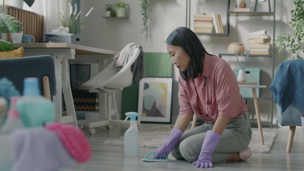 Woman Cleaning the Floor in a Living Room