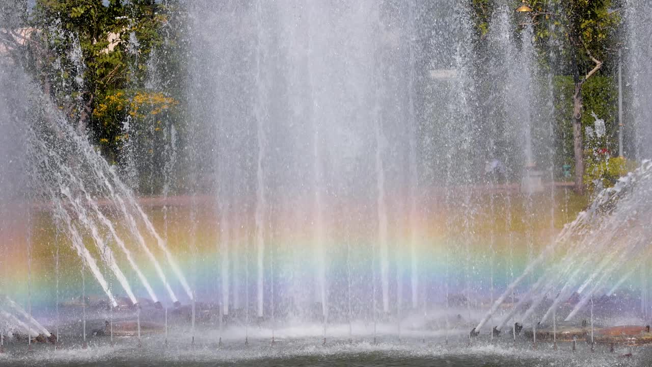 Colorful rainbow forms in a park fountain